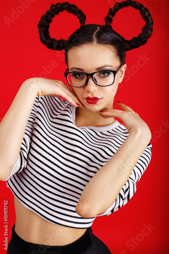 Fotografía High fashion girl in the glasses with unusual hairstyle like Minnie Mouse in the