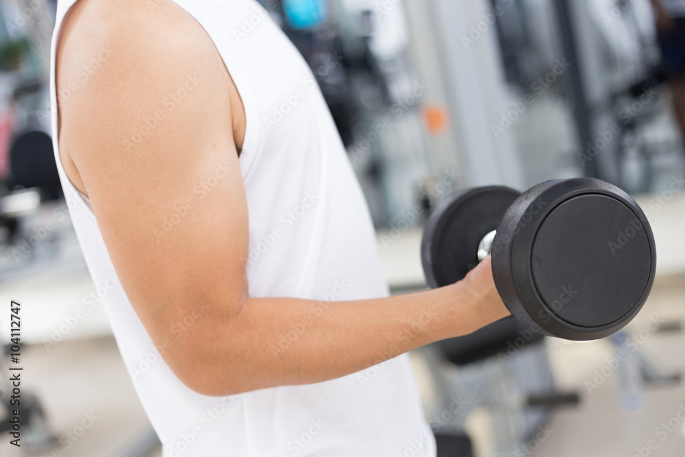 yound man working out in mdoern gym yound man working out in mdoern gym