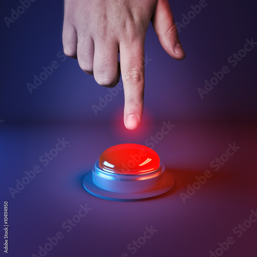 Pushing A Panic Button. A person about to press a big red button.