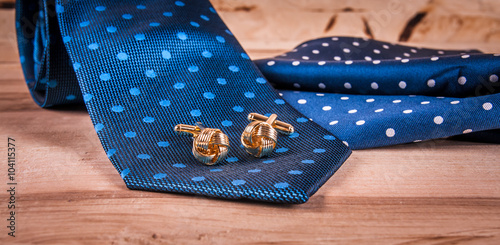 silver cuff links and red bow tie
