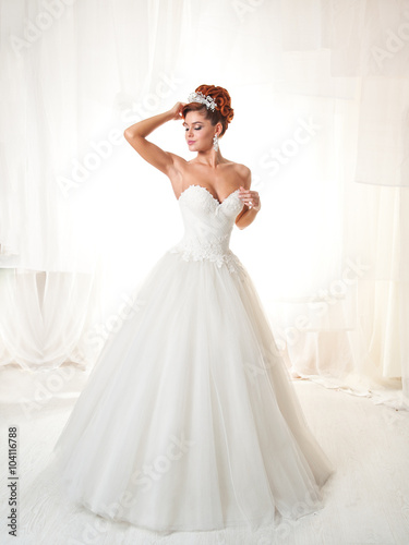 Gorgeous bride in a white elegant room