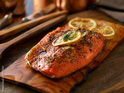 cooked salmon fillet on top of wooden cedar plank