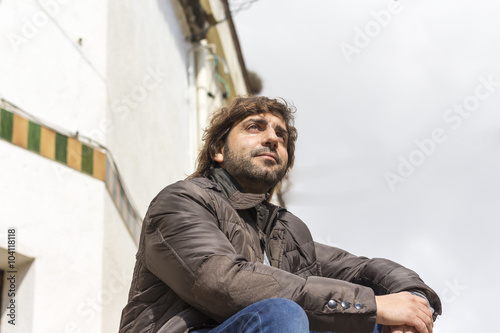 Serious man sitting on steps