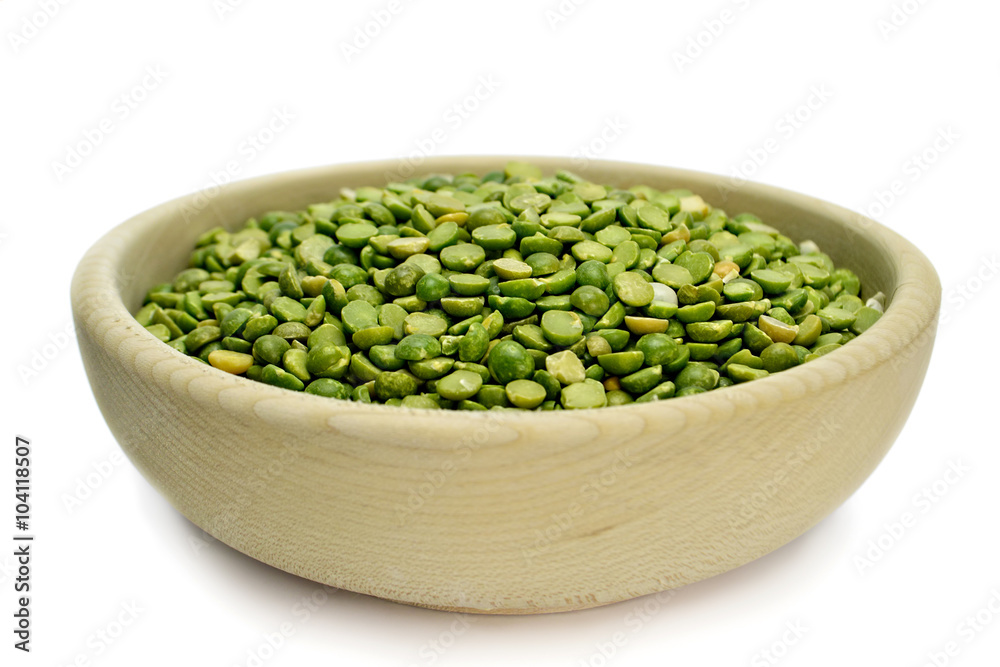 Split peas in wooden bowl isolated on white background