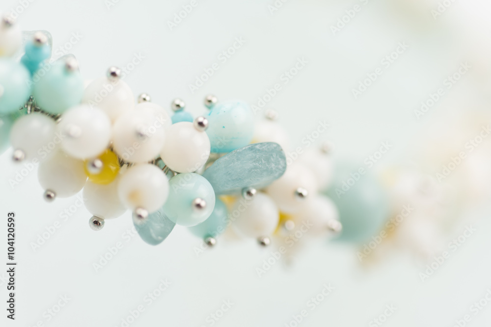 Natural mineral women necklace. Beauty and fashion background with partly defocused different color beads.