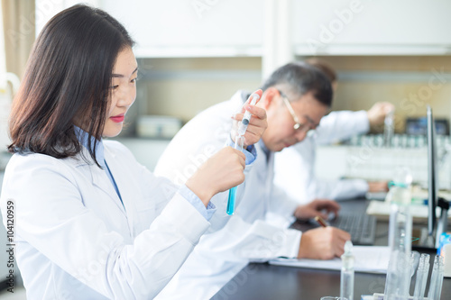 people doing chemical experiment in modern lab