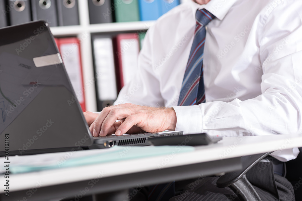 Businessman typing on laptop computer Businessman typing on laptop computer