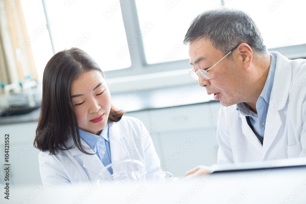 people doing chemical experiment in modern lab people doing chemical experiment in modern lab