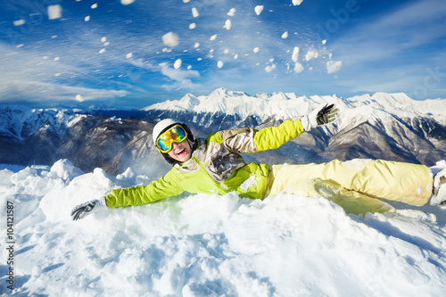 Happy woman in ski outfit throw snow up