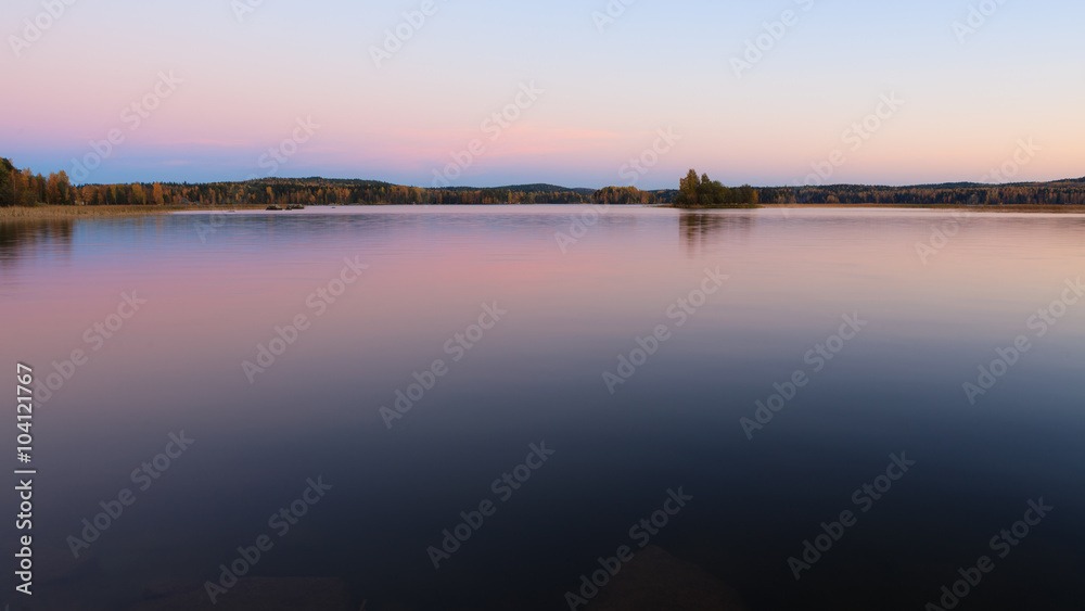 Serene lake scenery at dusk in Finland