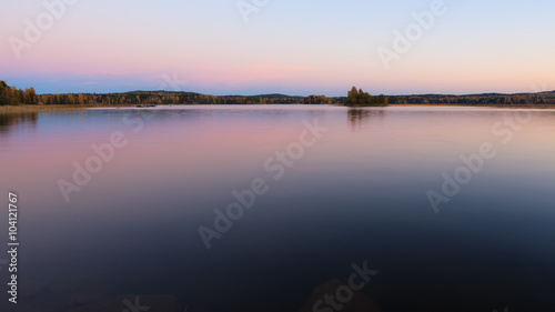 Serene lake scenery at dusk in Finland