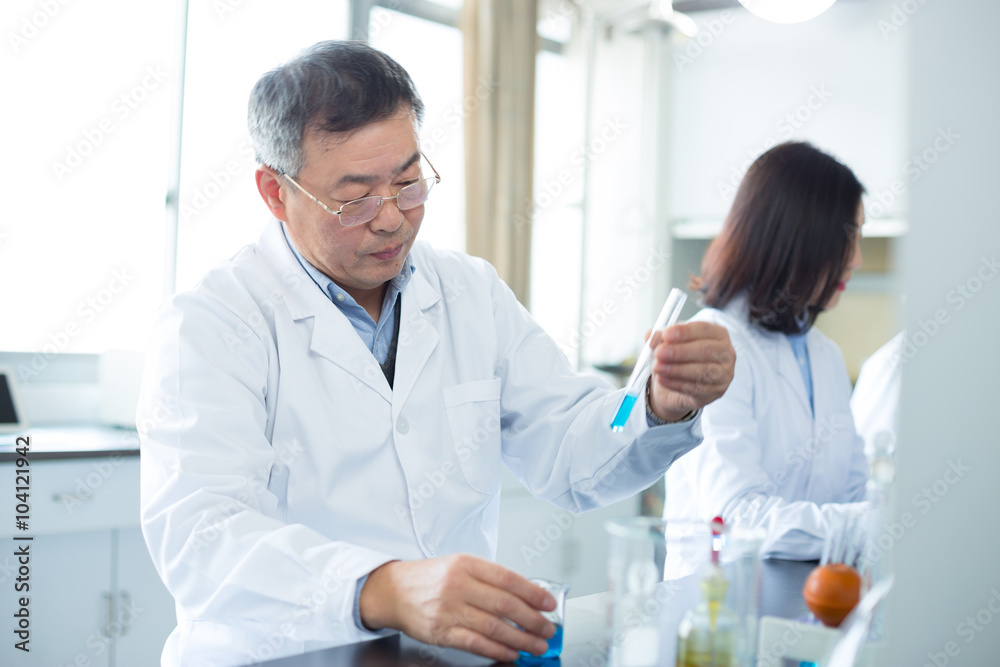 people doing chemical experiment in modern lab people doing chemical experiment in modern lab