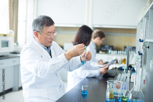 people doing chemical experiment in modern lab