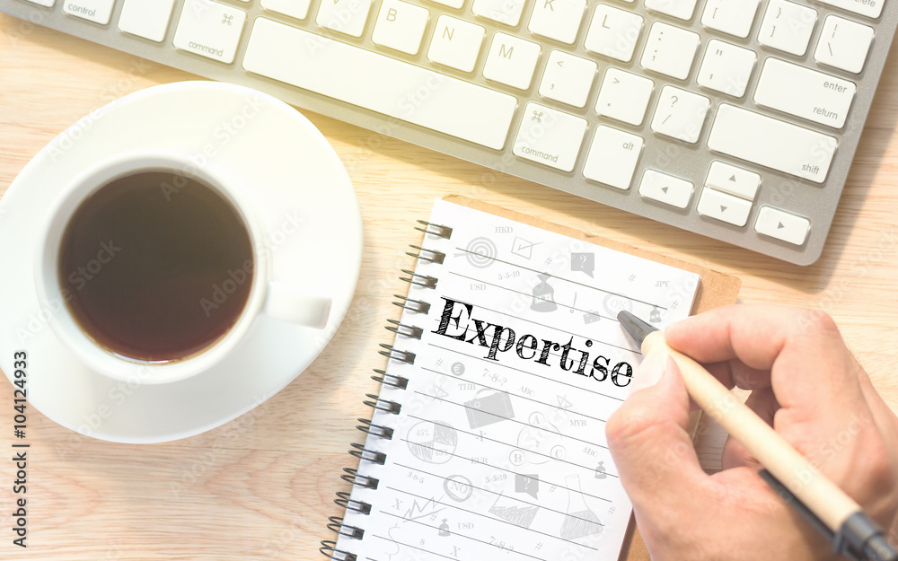 Hand writing on book message Expertise. A keyboard and a glass coffee table.Vintage tone. Hand writing on book message Expertise. A keyboard and a glass coffee table.Vintage tone.