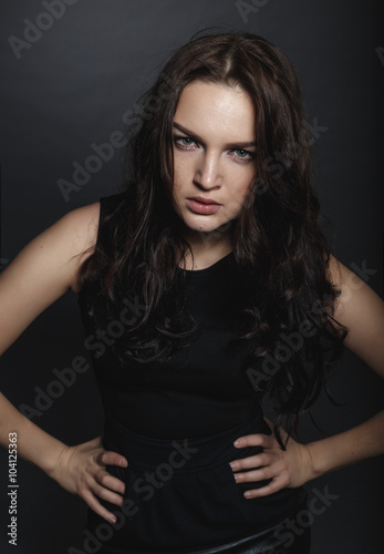 High fashion sensual girl in the black dress in the studio