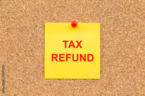 Yellow blank note and written TAX Refund for reminder.