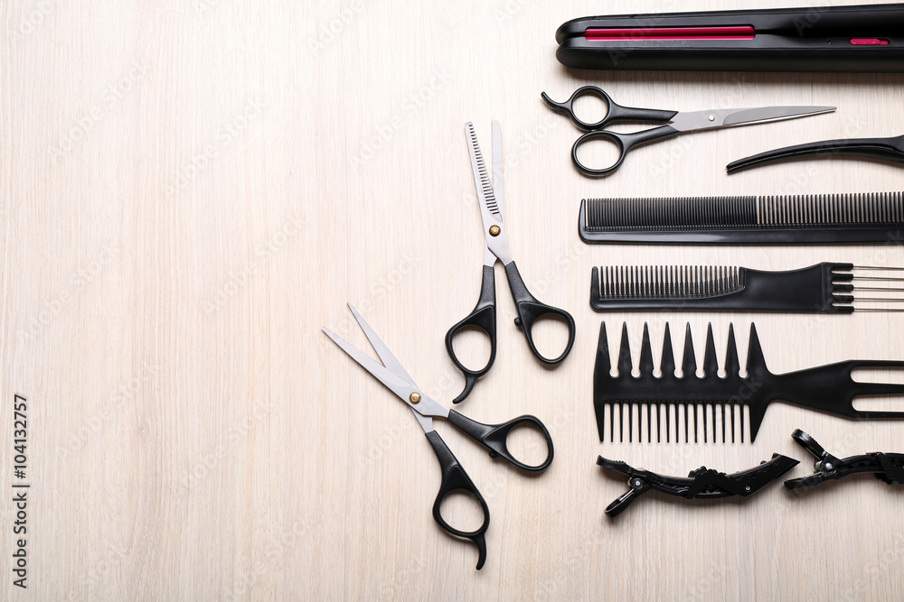 Barber set with tools and equipment on light wooden table Barber set with tools and equipment on light wooden table