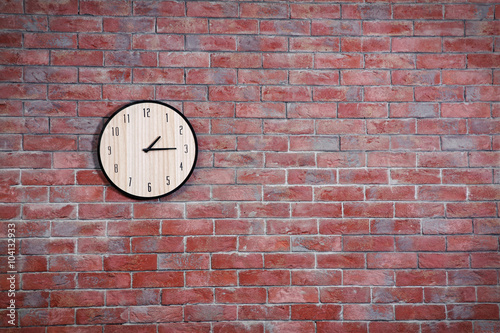 Clock on brick wall background