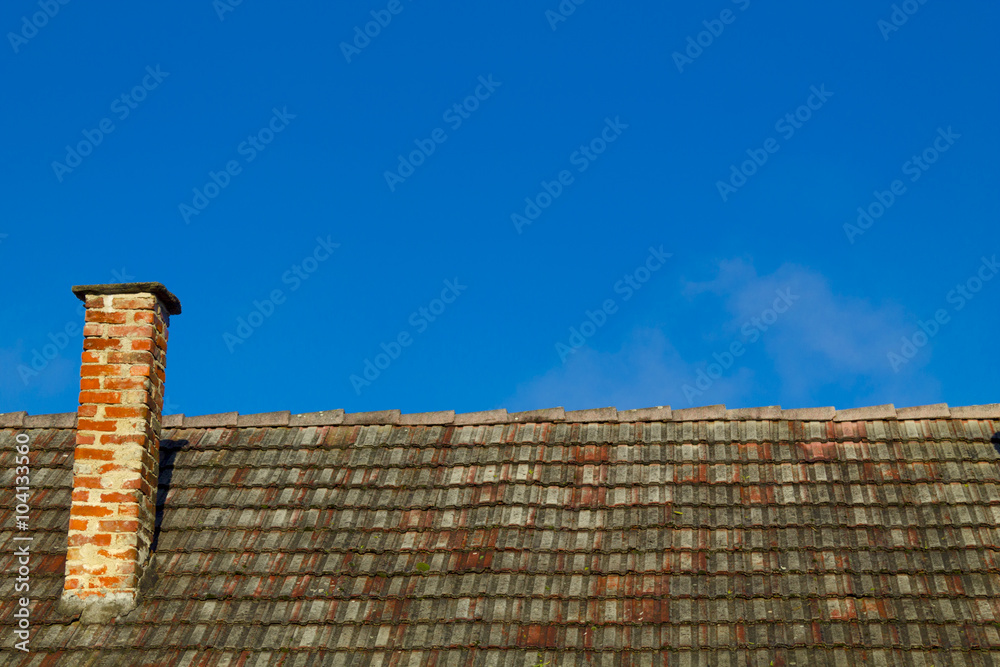 Roof chimney on a blue sky
