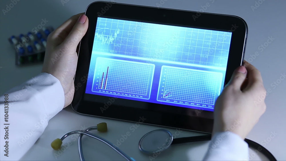 Epidemiologist investigating patterns of disease, comparing statistics on tablet Epidemiologist investigating patterns of disease, comparing statistics on tablet