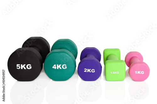 Fitness dumbbells. Black, green, pink and purple dumbbells isolated on white background. Weights for a fitness training.