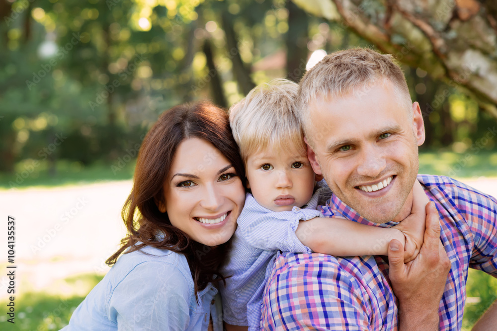 Close-up of happy family spending time together in the park Close-up of happy family spending time together in the park