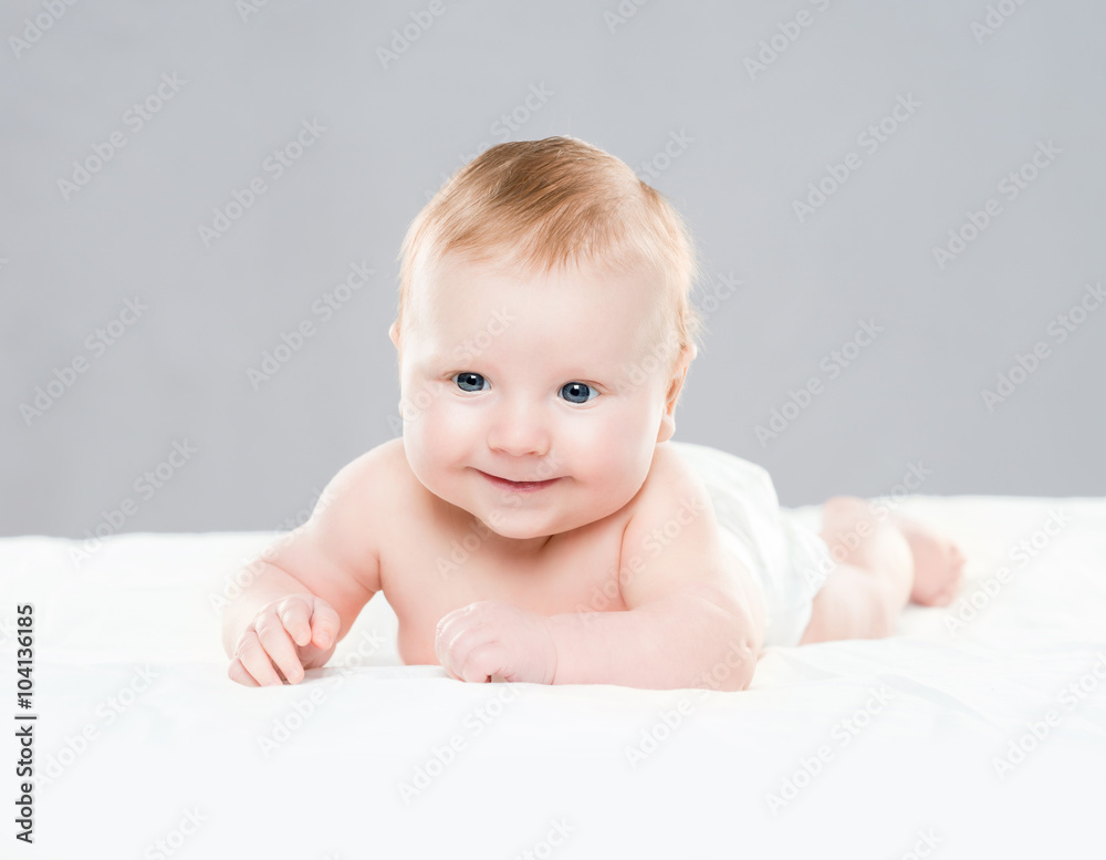 Portrait of a cute smiling infant baby crawling in a diaper. Portrait of a cute smiling infant baby crawling in a diaper.