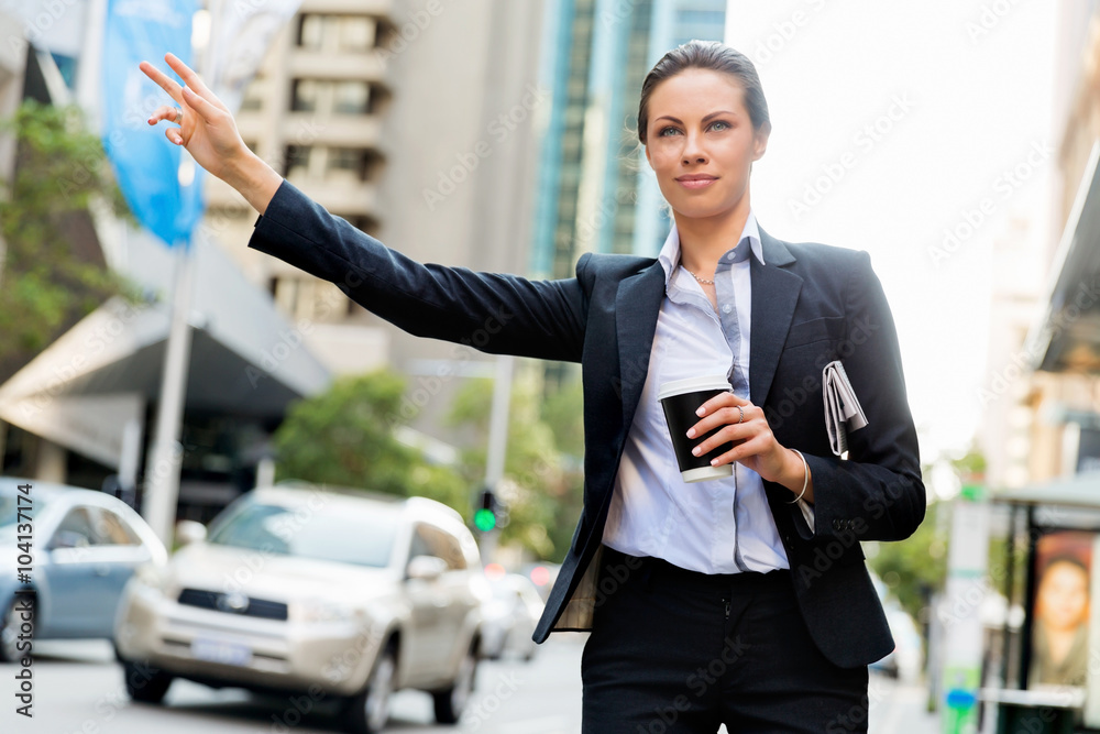 Portrait of business woman catching taxi Portrait of business woman catching taxi