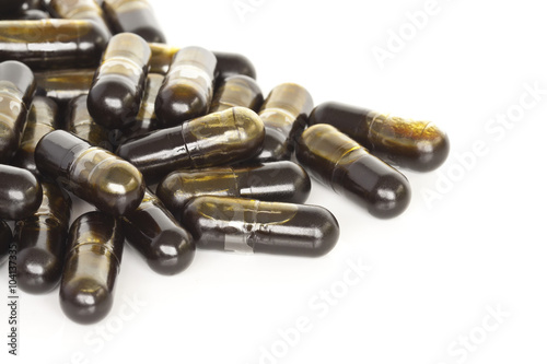 Olive Leaf Vitamin Supplements. A pile of olive leaf supplement capsules isolated on a white background.