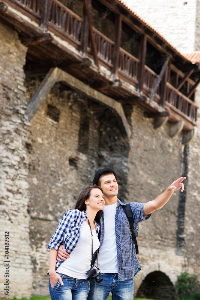 Young couple being tourists exploring the medieval buildings Young couple being tourists exploring the medieval buildings