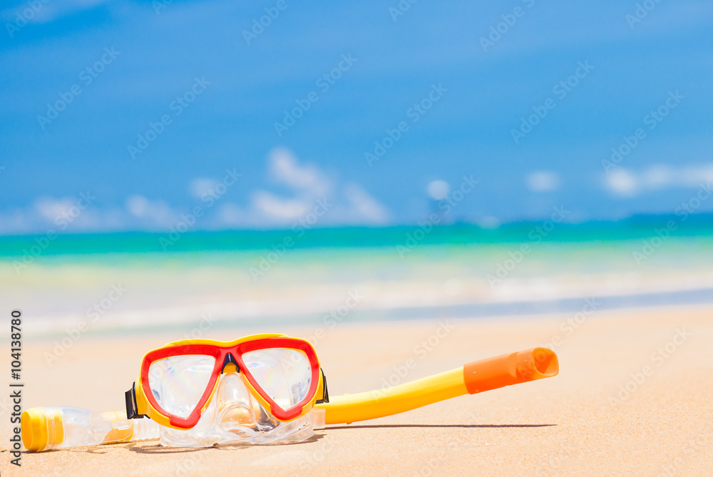 diving goggles and snorkel gear on sandy beach