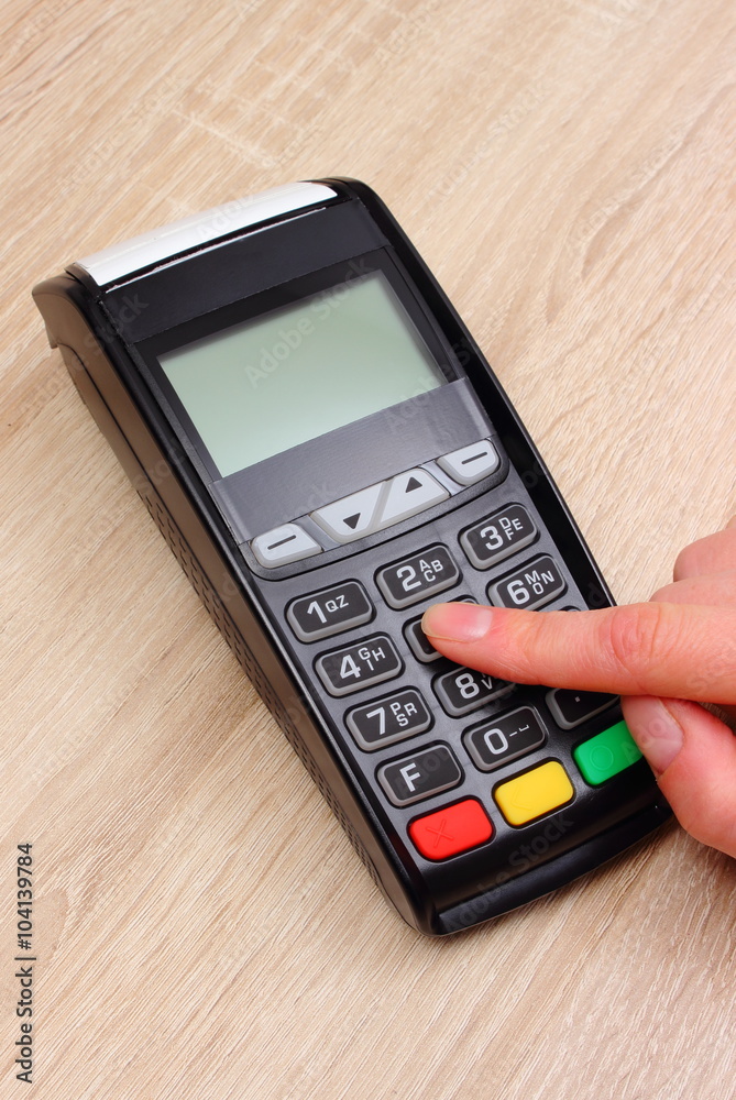 Hand of woman using payment terminal, enter personal identification number Hand of woman using payment terminal, enter personal identification number