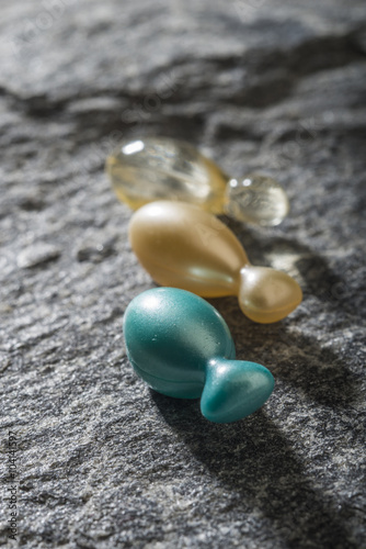 Gel capsules on a stone background
