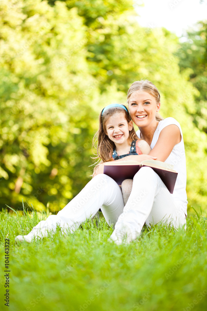 Mother and daughter learning about nature in park Mother and daughter learning about nature in park