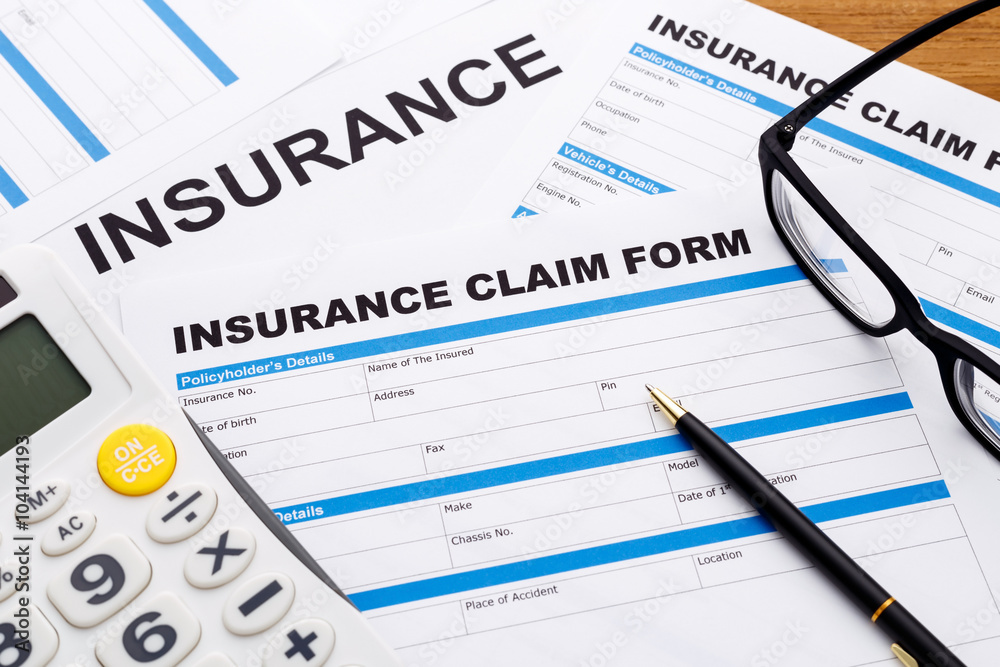 Insurance claim concept with pen and calculator Insurance claim concept with pen and calculator