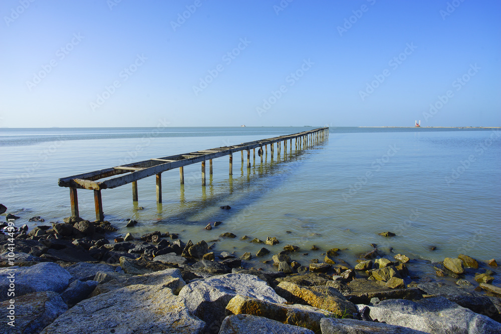 wooden pier in caribbean sea with beautiful blue sky and copy sp