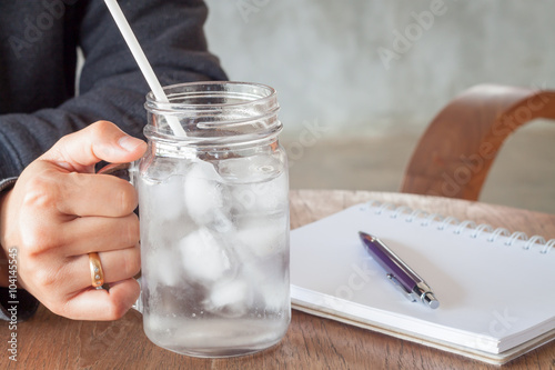 Woman's hand holding a cold glass of water
