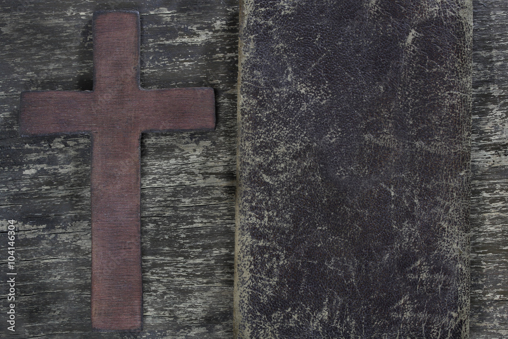 Cross and old leather  on old wooden board