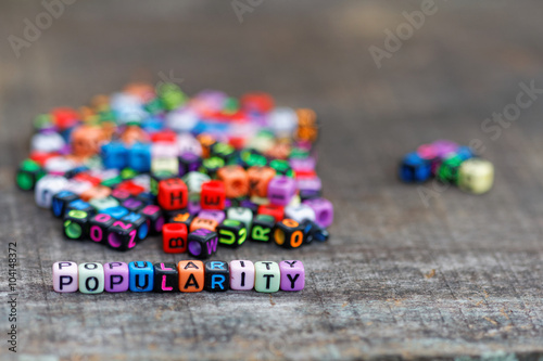 Popularity concept. Alphabet block with word popularity show two different group of block with majority behind the word popularity