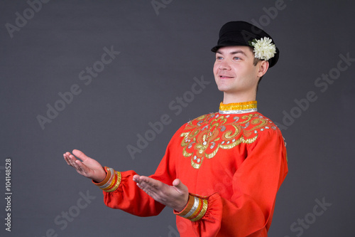 attractive russian guy dancing in folk costume