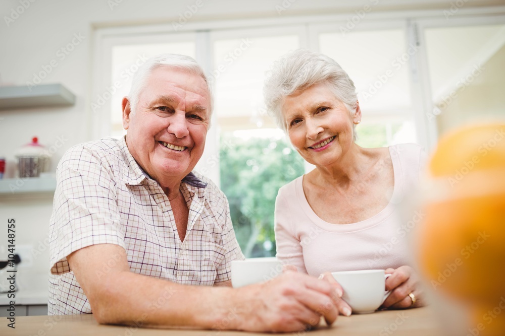 Portrait of senior couple smiling while having coffee Portrait of senior couple smiling while having coffee