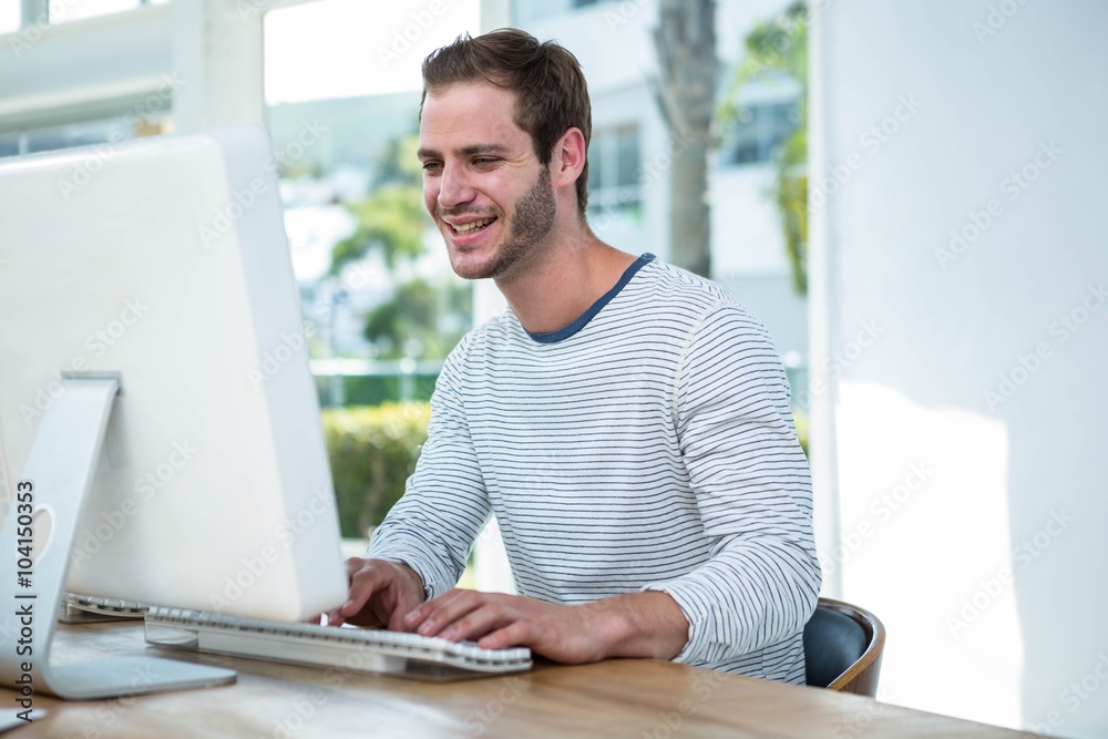 Handsome hipster working on computer Handsome hipster working on computer