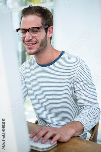 Handsome hipster working on computer