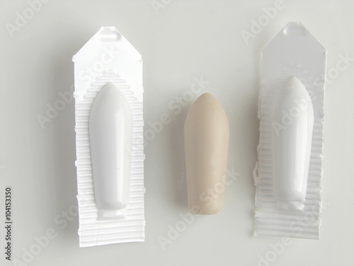 the suppository on the white background; shallow depth of field