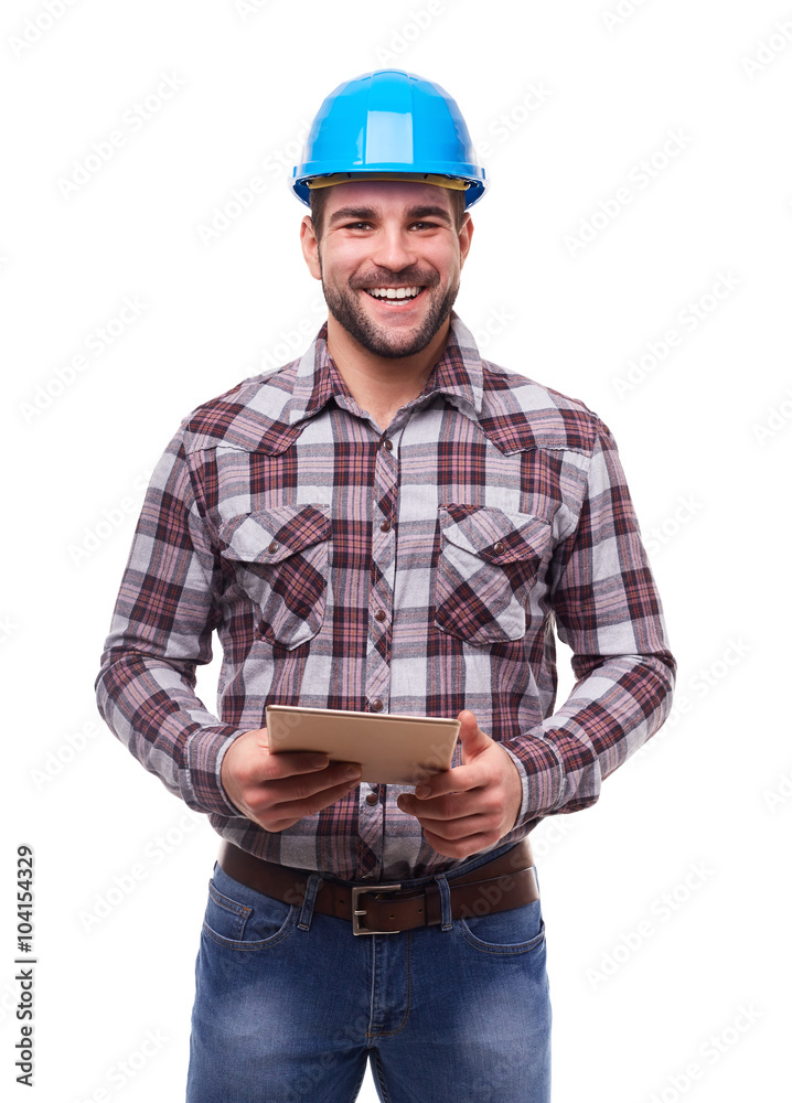Happy worker in blue helmet using a digital tablet Happy worker in blue helmet using a digital tablet