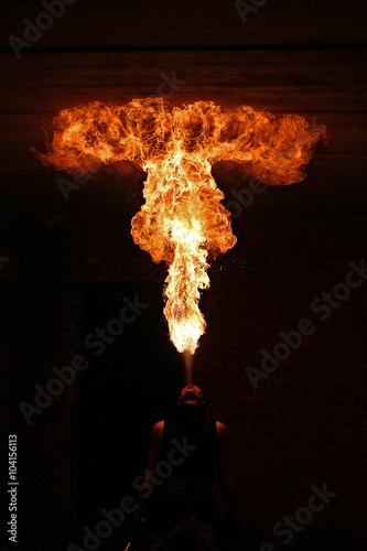 Fire artist performing fire breathing