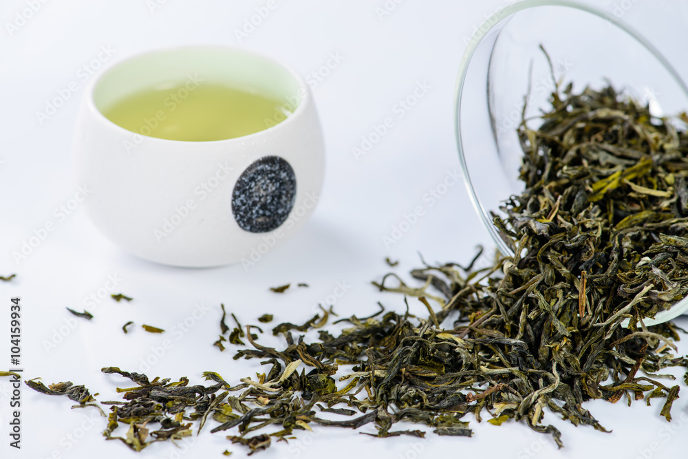 Fototapeta premium green tea Mengding, brewed in a cup and scattered tea, shallow D