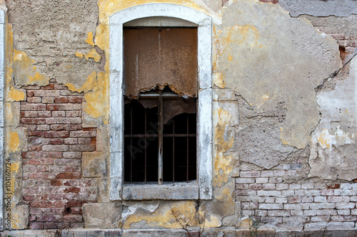 old brick wall with broken window