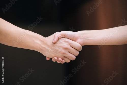 Close-up of people shaking their hands..