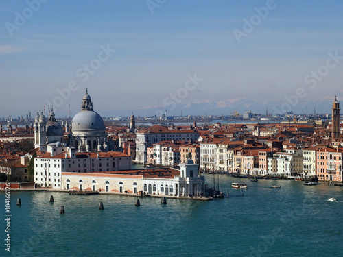 Venice - The Madonna della Salute Church and the Grand Canal, seen from the bell tower of the St. George Church and the Dolomiti mountains in background.